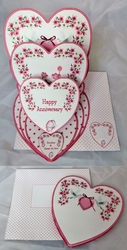 Pink and white triple heart easel anniversary card with matching envelope.