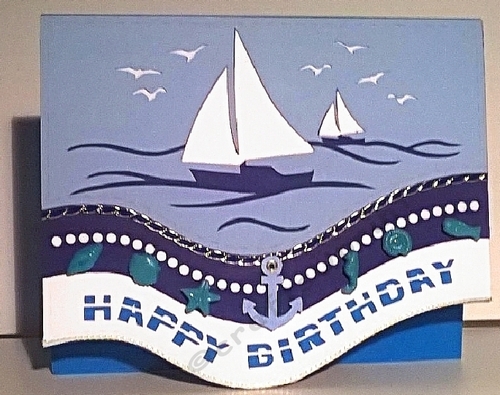 Shaped layered wavey card with boats on the sea