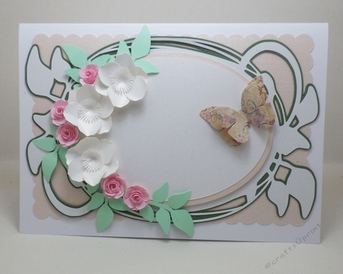 Oval with swirly leaves and flowers topper.