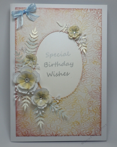 Oval frame and floral spray topper