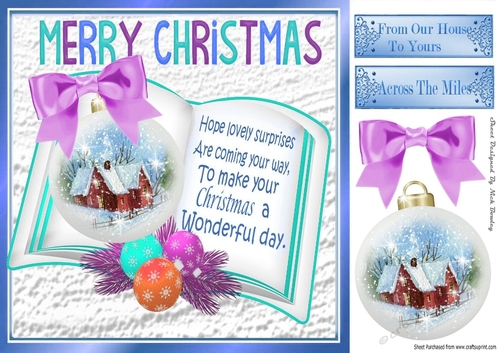 Pretty snow cottage bauble on open book with lilac bow 8x8