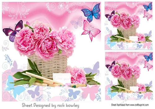 Pretty pink flowers with coloured butterflies in a basket 8x8