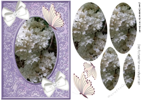 White flowers in purple ornate frame  with bows and butterflies oval pyramids
