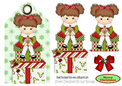 Little girl sitting on  christmas presents on a tag