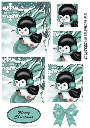 Penguin playing in the snow on turq sledge with bow,  pyramids