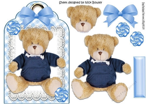 Lovely teddy in a blue jumper on lace with bow