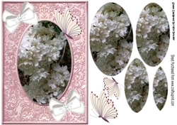White flowers in pink ornate frame  with bows and butterflies oval pyramids