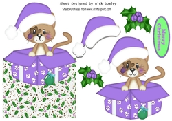 Cute little kitty in a purple santa hat in  xmas box with holly over the edge