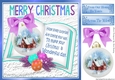 Pretty snow cottage bauble on open book with lilac bow 8x8