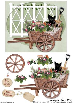 Cat in a Wheelbarrow Full of Flowers