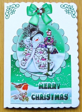 jolly snowman with robin in the snow over the edge with green bow by Joyce Watson