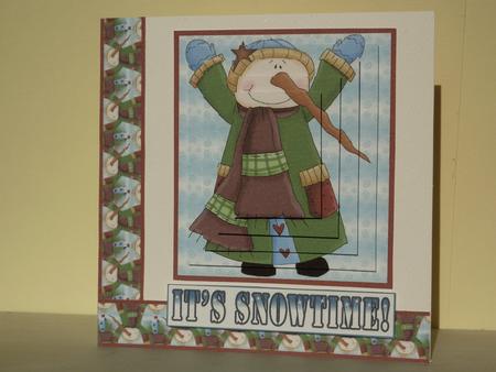 Snowman in Green Coat by Angela Butters