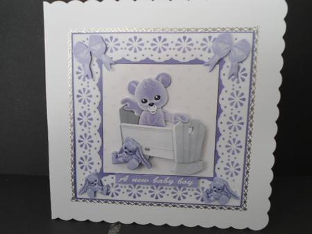 Blue Plushie in a Cradle by Angela Riley