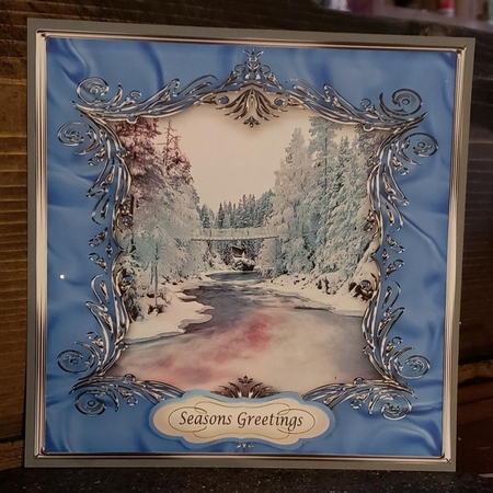 Winter scene in blue material frame with embellishments by Angela Taylor