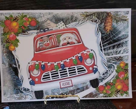 Santa in red car with rudolph A4 by Angela Taylor