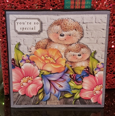 Hedgehogs and flowers by Angela Taylor