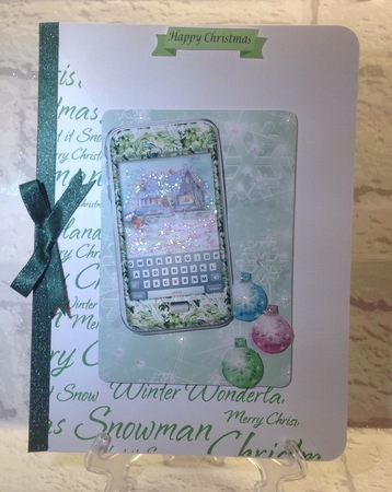 Green phone with winter cottage, snow and bauble background by Anita Henery