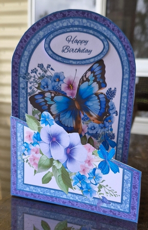 Cutaway Blue butterflies with flowers by Lorrae Nicklen