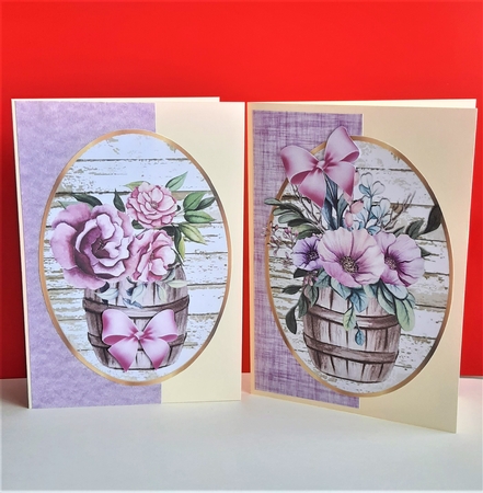 Two pretty flowers in barrel toppers with bows by Anne Jackson