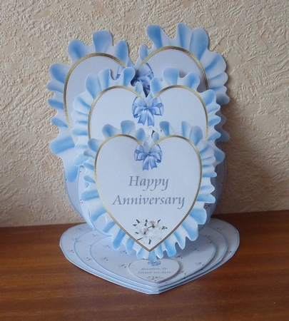 Blue anniversary triple heart easel card and matching envelope. by Anne Jackson