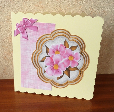 pretty pink flowers on a ornate topper with corner bows by Anne Jackson