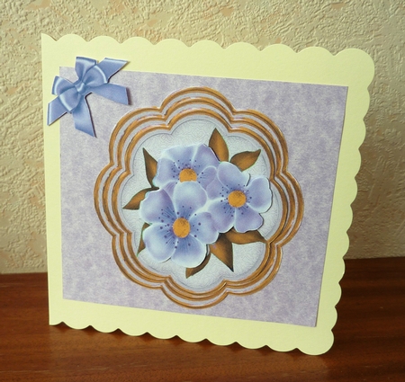 pretty purple flowers on a ornate topper with corner bows by Anne Jackson