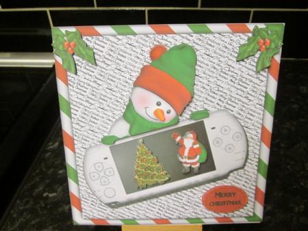 Game Console with Snowmen Peeking Qc by Anne-marie Wheeler