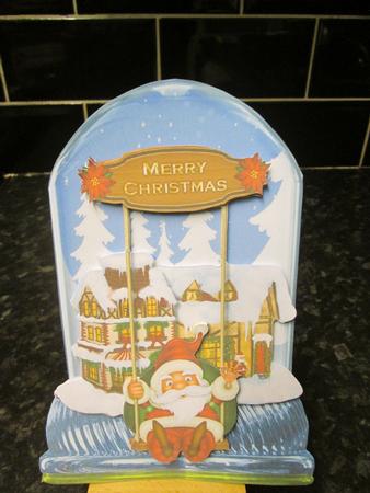 Globe Santa on Swing by Anne-marie Wheeler