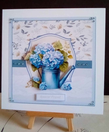 Watering can of blue flowers 7x7 by Benita Jenkinson