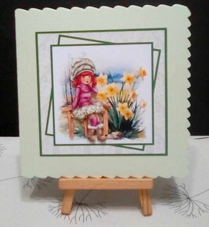 Girl sitting beside the daffodils 7x7, decoupage, insert and toppers by Benita Jenkinson
