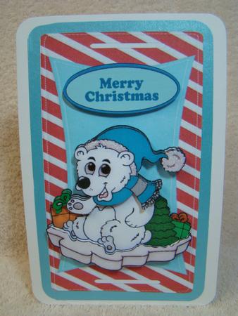 Polar Bear Playing on Ice with Hat on a Tag by Beverly Carmichael