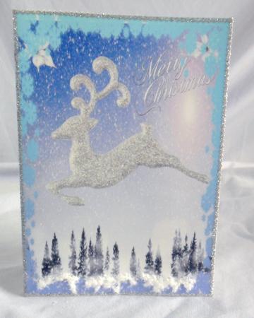 Silver Reindeer Flying Over a Snowy Woodland A4 by Brenda Needham