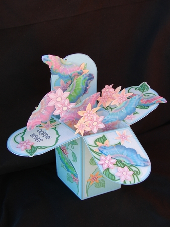 Flowers and butterflies in blue faux brick and floral box by Carolyn Norris