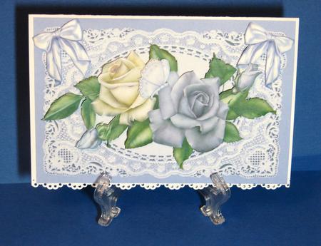 Purple/cream Roses on Lace with Bows by Carolyn Norris