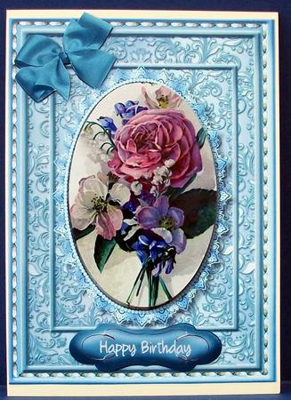 Lovely Flowers on a Blue Oval Frame by Cheryl French
