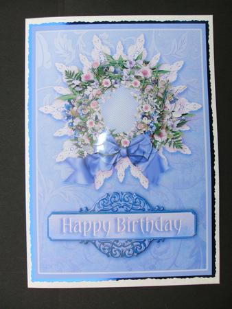 Purple Mixed Floral Wreath on a Lace Doily Pyramage by Christine Sutton