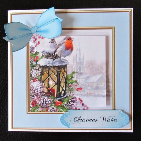 Pretty robin on a lantern in a 6x6 snow scene pyramids (blue) by Davina Rundle