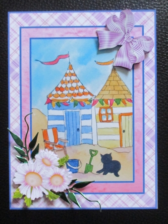 A5 beach scene with beach huts. bucket and spade and black cat. Card topper with decoupage by Davina Rundle