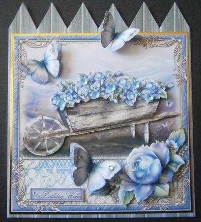 Blue Roses Wheelbarrow by Davina Rundle