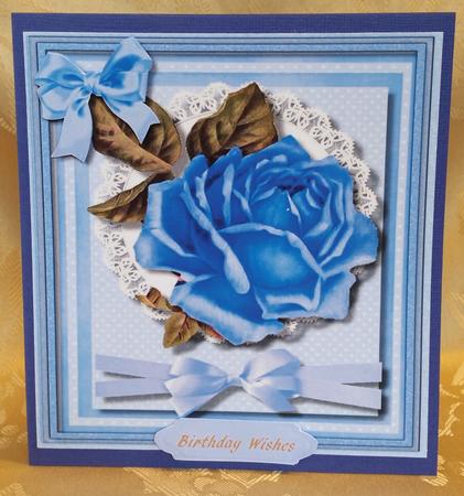 Beautiful Blue Rose on Lace with Ribbon Bow by Deloraine Neubauer