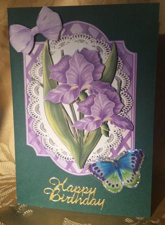 Pretty Purple Iris Flowers on Lace with Bow by Deloraine Neubauer