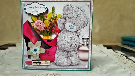 Tatty teddy with flowers, perfume and shoes by Diane Carbis
