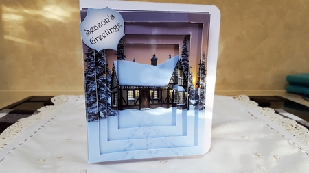 pretty cottage in the snow with bow and stars, tunnel pyramids by Diane Carbis