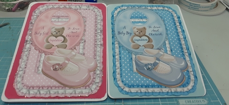 A baby boy and a baby girl toppers by Diane Carbis