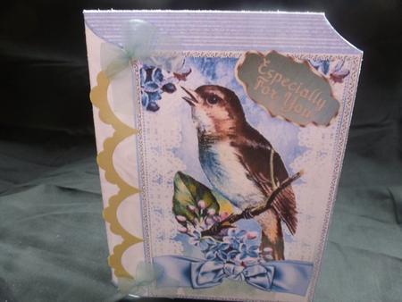 Bird on a Branch with Blue Bow Folded Book by Diane  Hitchcox