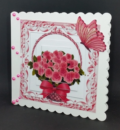 Pretty pink roses roses in a basket, with butterfly pyramids by Diane  Vermeer