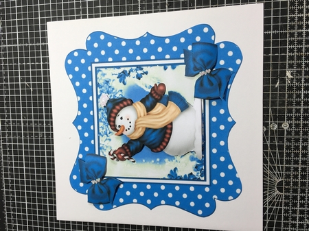 lovely snowman in blue polkadot frame with bows 7x7 by Donna Girling