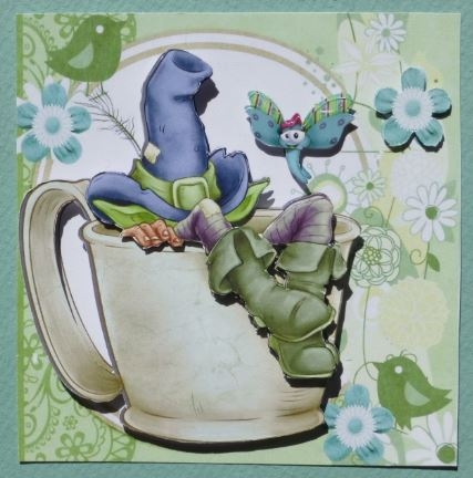 Gnome in Blue Hat Taking a Nap in a Teacup by Donna Ritchie