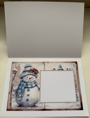 Snowman In Snowy Town A5 Card by Erika Sissons