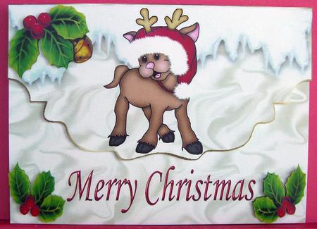 Cute Reindeer in the Snow with Santa Hat On by Eunice Roberts